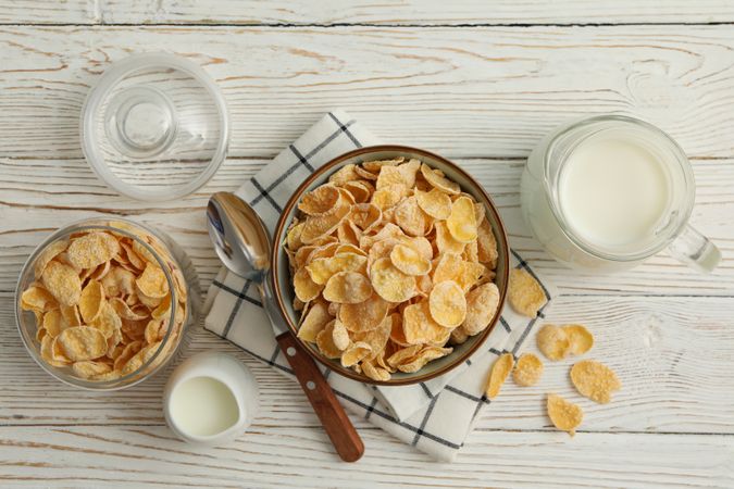 Concept of breakfast with muesli and milk on wooden table