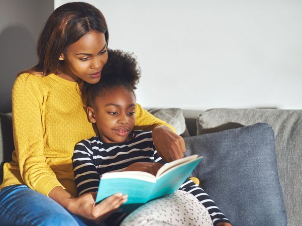 Black mother and daughter enjoy story time