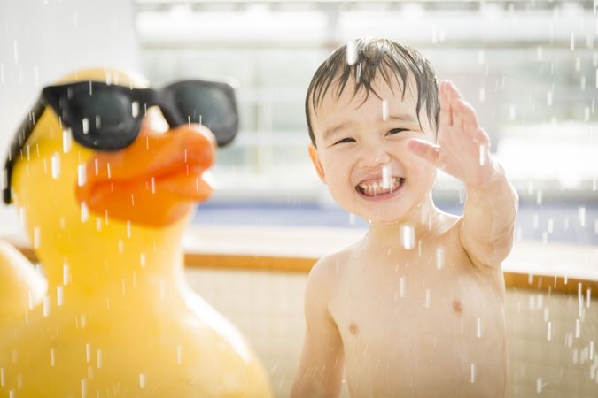 Waving Boy Having Fun at the Water Park