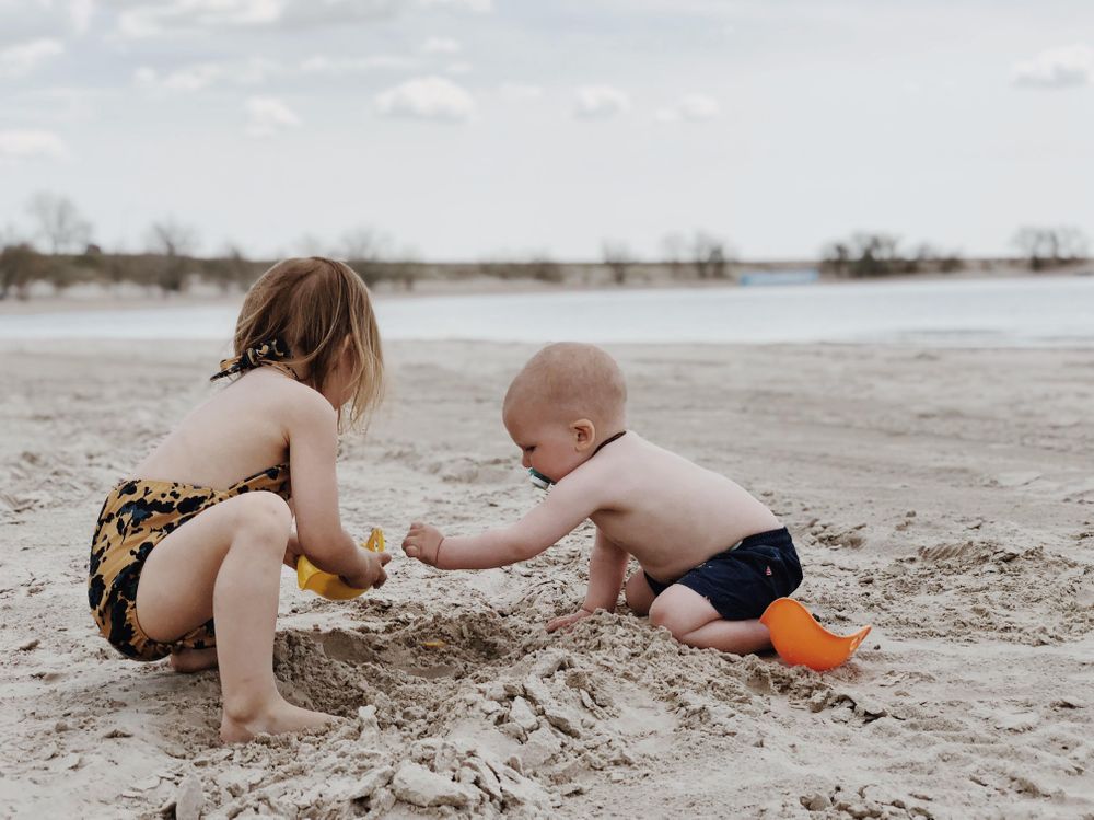 Two kids playing in the sand