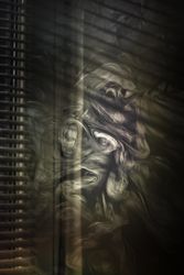 Smoke swirling in dark room with blinds