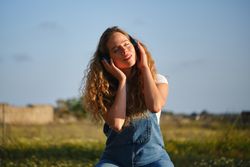 Woman listening to music via headphones in nature