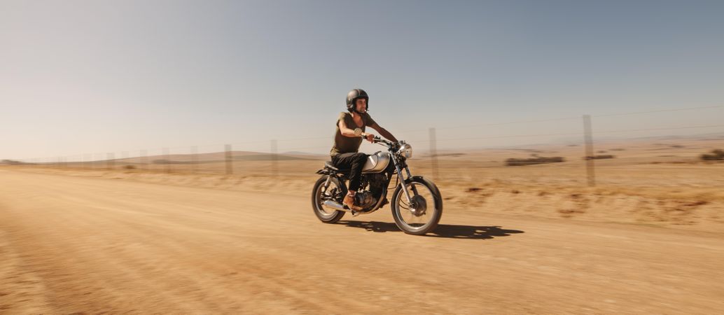 Young man riding motorbike off-road