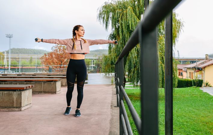 Young woman training with dumbbells