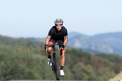 Professional cyclist riding bike in park