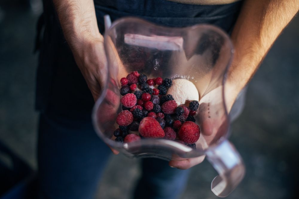 Preparing recipe for smoothie or healthy blended drink for fitness diet