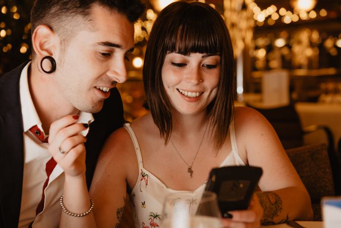 Couple using smartphone in luxury restaurant