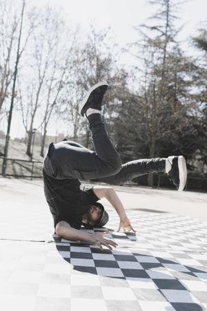 Man dancing break dance in park