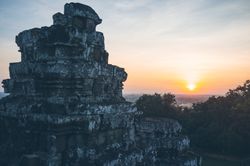 Ancient temple against sunset sky