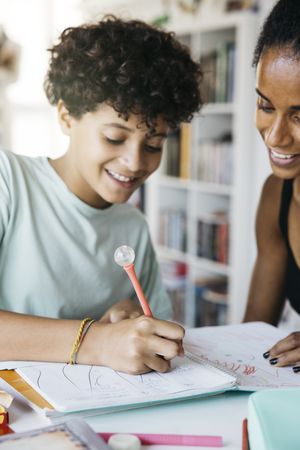 Girl doing her homework with mother