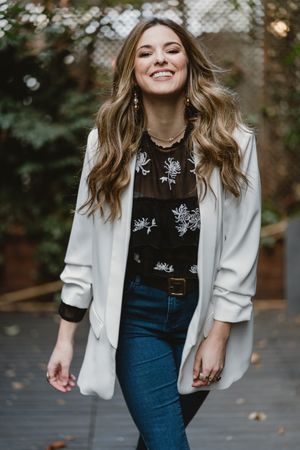 Woman standing on planter in garden