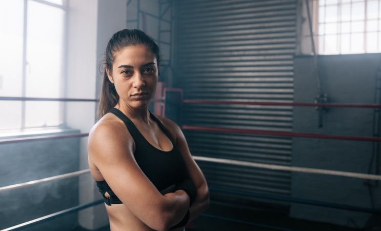 Portrait of female boxer in the boxing studio