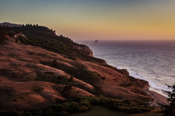 Top of rocky cliffs looking down at Pacific Ocean