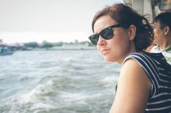 Woman looking at waving sea from ship