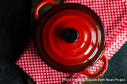 Top view of red cast iron pan on kitchen towel 4jVEZx