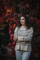 Fashion woman on a background of red and yellow autumn leaves