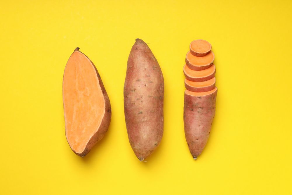 Fresh cut sweet potato on a yellow background