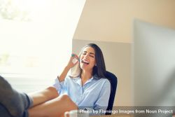 Female smiling using toothbrush in bright room 4Mm3E4