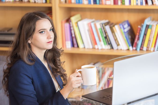 Businesswoman concentrating and taking a coffee break