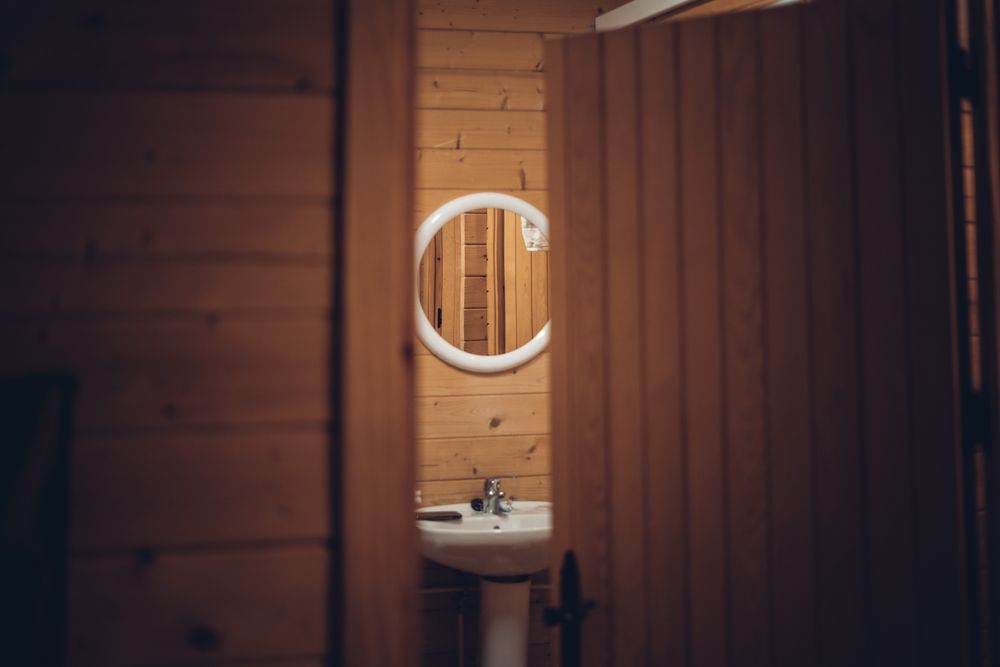 Bathroom in wooden house with opened door