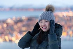 Joyful millennial woman enjoying view of night city