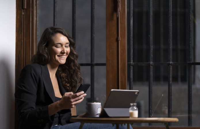 Young female using a mobile phone in cafe
