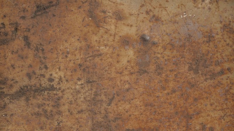 Old rusted metal wall with corroded surface and vintage industrial patina