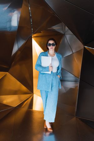 Woman with laptop in futuristic studio