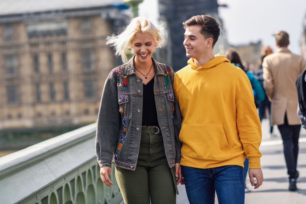 Male and female friend walking in London