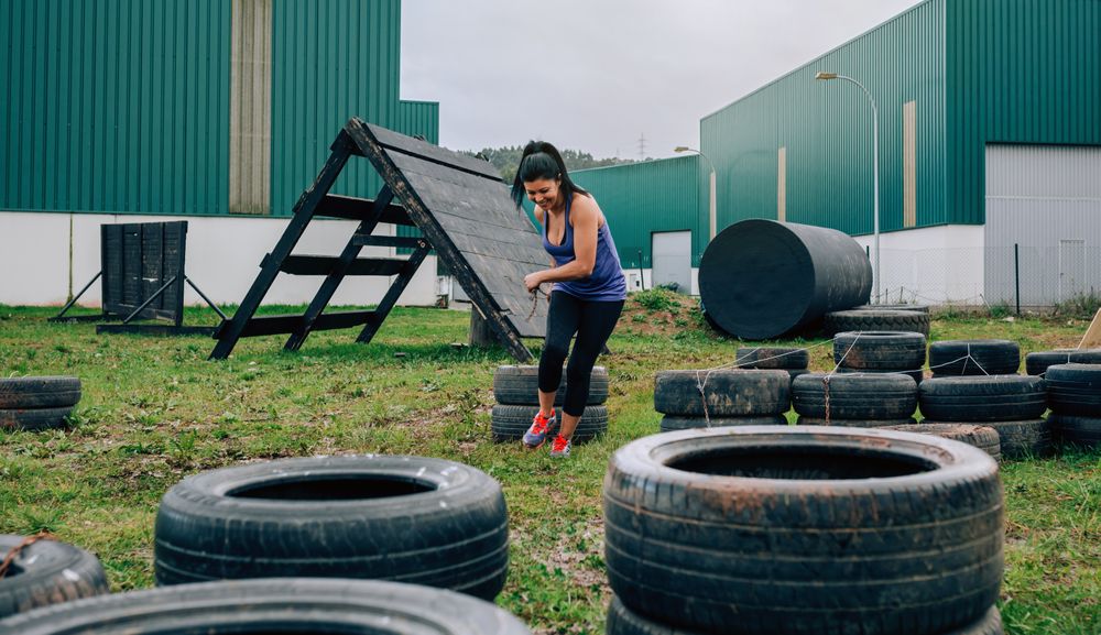 Participant in an obstacle course dragging wheels