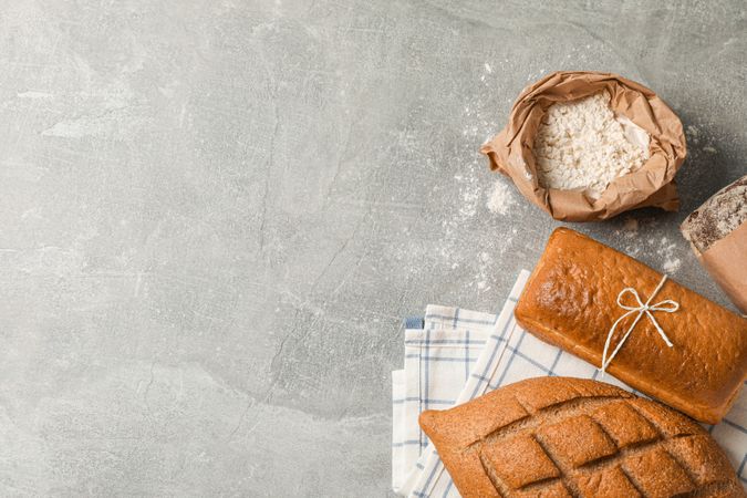 Bakery products composition on grey background, top view and space for text