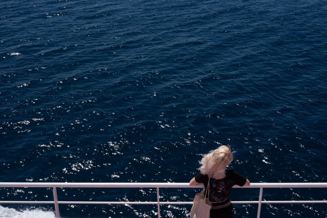 Looking down at blonde woman on deck of boat