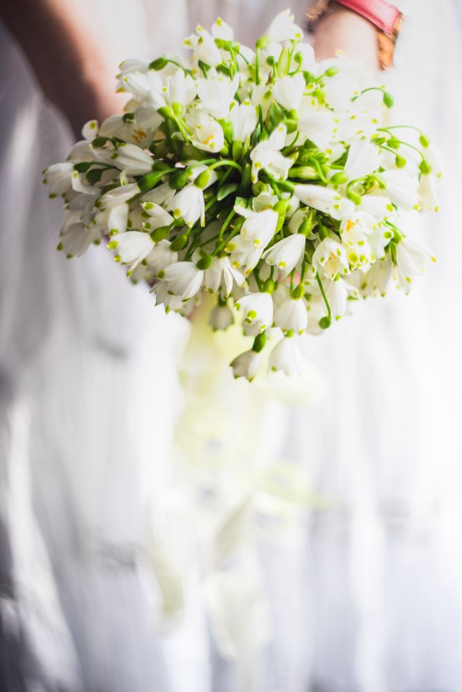 Woman holding bouquet with snowdrops