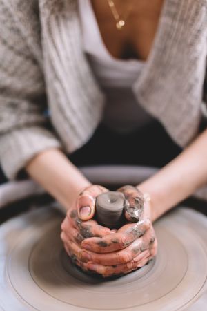 Crop potter shaping vessel on wheel