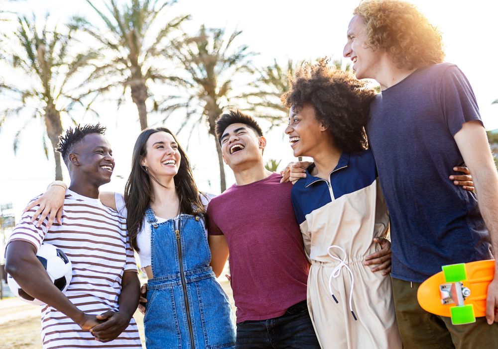 Multiracial friends standing together enjoying summertime on holidays
