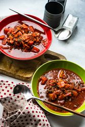 Two bowls of traditional Ukrainian beetroot soup borscht