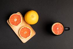 Grapefruits for breakfast near mug and board
