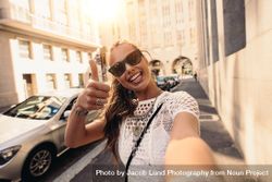 Beautiful woman giving a thumbs up to camera 4Ar9Wb