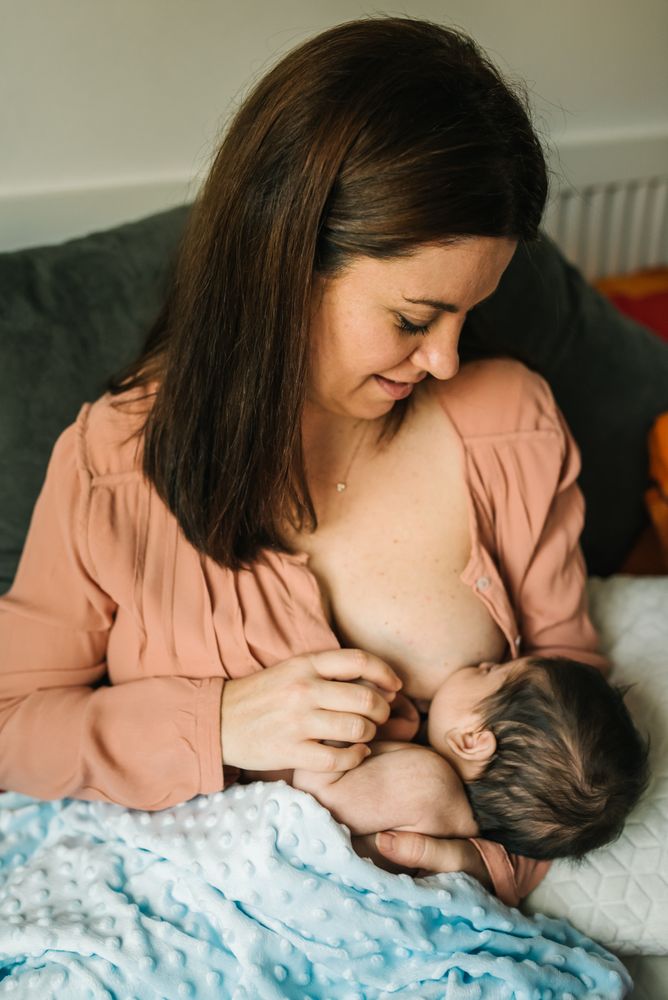 Mom breastfeeding at home