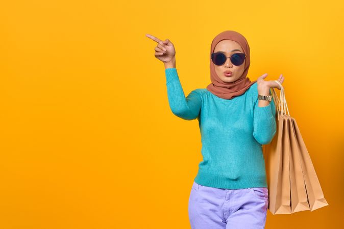 Fabulous Muslim woman smiling with shopping bags