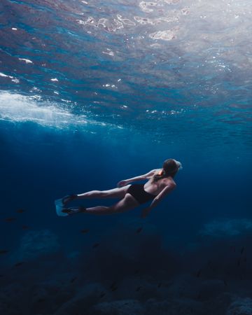 Underwater shot of woman in swimsuit diving