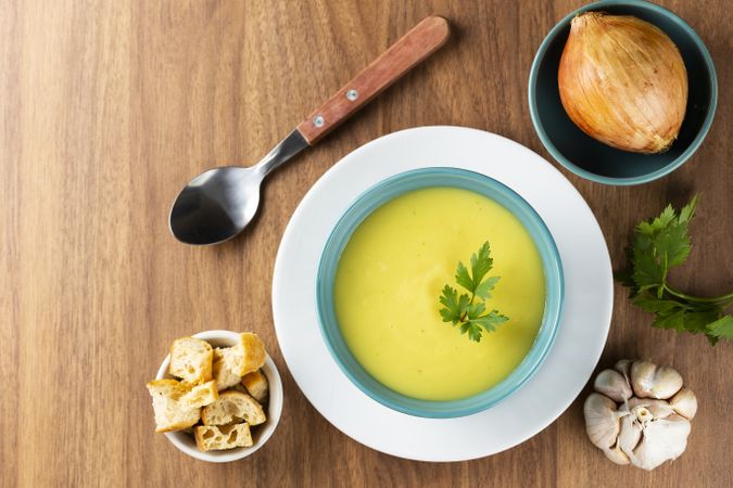 Bowl with onion soup and croutons on the table.