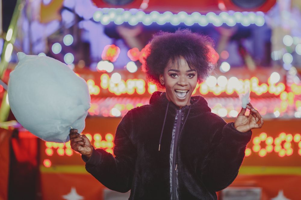 Cheerful Black woman with candy floss