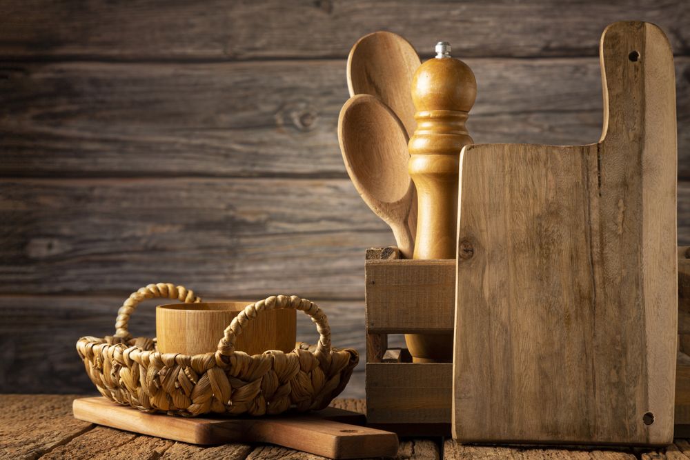 Wooden kitchen utensils on rustic background.
