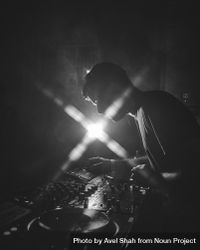 London, England, United Kingdom - Nov 9, 2022: B&W shot of side view of man DJ-ing with flare 4dVPN0