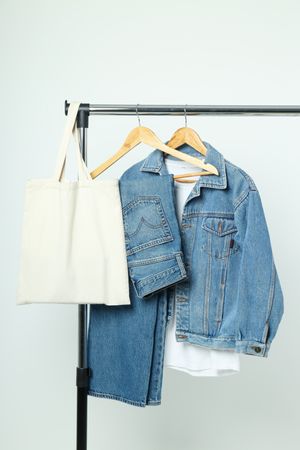 A denim suit on a hanger
