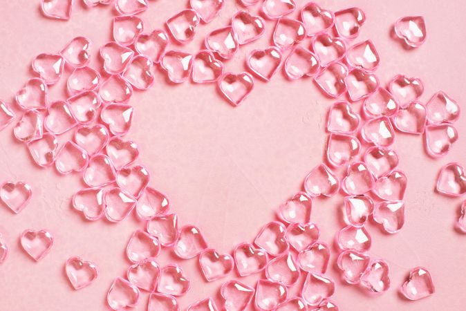 Clear hearts on pink background making the shape of heart
