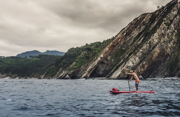 Man on paddleboard floating in sea