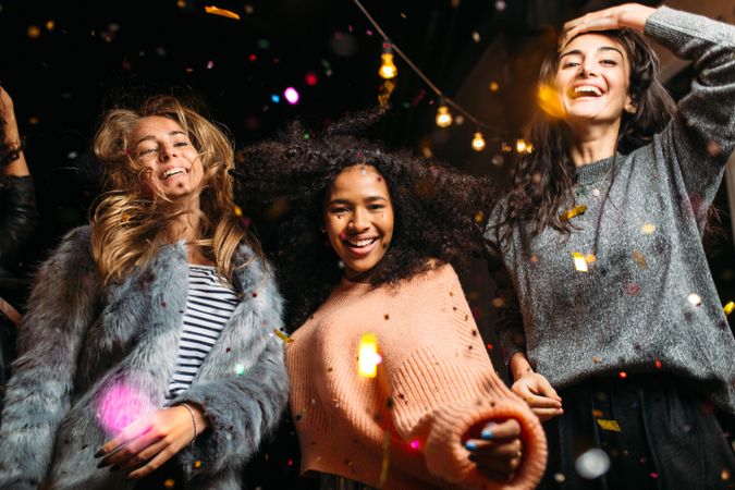 Stylish multi-ethnic women dancing at party