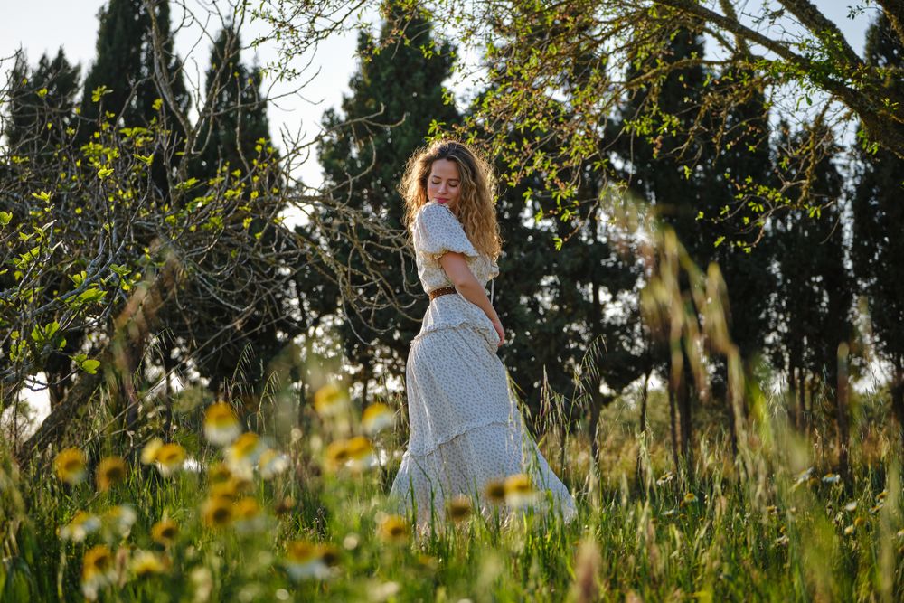 Woman in sundress standing on lush lawn